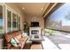 Cozy covered patio with an outdoor fireplace, TV, and views of the backyard at 20558 N 263Rd Dr, Buckeye, AZ 85396