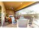 Comfortable covered patio with a fireplace, ceiling fan, and views of the pool and landscaping at 20558 N 263Rd Dr, Buckeye, AZ 85396