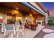 Inviting covered patio with comfortable seating, fireplace, and outdoor dining area at 20558 N 263Rd Dr, Buckeye, AZ 85396