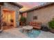 Cozy covered patio with comfortable seating, a decorative rug, and easy access to the backyard at 20558 N 263Rd Dr, Buckeye, AZ 85396