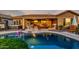 Inviting backyard pool with a covered patio, hot tub, and comfortable seating offers a perfect oasis at 20558 N 263Rd Dr, Buckeye, AZ 85396