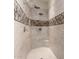 Walk-in shower with sleek tile design and a convenient built-in seat at 20558 N 263Rd Dr, Buckeye, AZ 85396