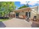 This cozy backyard offers a covered patio with a dining table and a swing for relaxing and entertaining at 2407 W Rue De Lamour Ave, Phoenix, AZ 85029