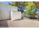 The backyard has extra storage with a white shed and a small patch of artificial turf at 2407 W Rue De Lamour Ave, Phoenix, AZ 85029