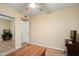 Bedroom featuring a desk, antique sewing machine, and mirrored closet doors at 2407 W Rue De Lamour Ave, Phoenix, AZ 85029
