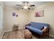 Bright bedroom with comfortable futon and modern ceiling fan at 2407 W Rue De Lamour Ave, Phoenix, AZ 85029