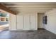 This carport features two storage areas with doors and a window with bars for added protection at 2407 W Rue De Lamour Ave, Phoenix, AZ 85029
