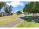 Lush green grass and mature trees surround the walking path in this well-kept community at 2407 W Rue De Lamour Ave, Phoenix, AZ 85029