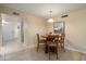 Dining room with tile flooring, chandelier, and neutral paint at 2407 W Rue De Lamour Ave, Phoenix, AZ 85029