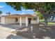 Charming single-story home with covered parking, desert landscaping, and mature shade tree at 2407 W Rue De Lamour Ave, Phoenix, AZ 85029