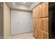 Kitchen with cabinets and convenient access to laundry area behind doors at 2407 W Rue De Lamour Ave, Phoenix, AZ 85029