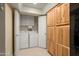 Laundry area behind doors in the kitchen with cabinets above machines at 2407 W Rue De Lamour Ave, Phoenix, AZ 85029