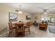 Living and dining area with tile flooring, chandelier, neutral paint, and patio access at 2407 W Rue De Lamour Ave, Phoenix, AZ 85029