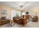 Inviting living room features neutral tones, tile floors, and comfortable, plush furniture at 2407 W Rue De Lamour Ave, Phoenix, AZ 85029