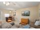Open living area features tile flooring, television, and comfortable seating at 2407 W Rue De Lamour Ave, Phoenix, AZ 85029