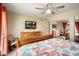 Bright main bedroom with wood floors, ceiling fan, and closet mirror at 2407 W Rue De Lamour Ave, Phoenix, AZ 85029