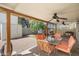 The outdoor covered patio features a dining table, ceiling fans, a storage shed and a charming swing at 2407 W Rue De Lamour Ave, Phoenix, AZ 85029