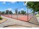 Fenced outdoor tennis court offers a place for recreational activity in the community at 2407 W Rue De Lamour Ave, Phoenix, AZ 85029