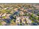A beautiful aerial view of a well-maintained neighborhood featuring tile roofs and mature trees at 250 W Juniper Ave # 22, Gilbert, AZ 85233
