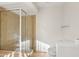 Bathroom featuring neutral tiling, frameless shower, toilet, and natural light from the window at 250 W Juniper Ave # 22, Gilbert, AZ 85233