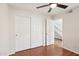 Bedroom features laminate floors, ceiling fan, and large closet at 250 W Juniper Ave # 22, Gilbert, AZ 85233