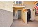 Close-up of a home's entryway with a gray door, American flag and textured walls at 250 W Juniper Ave # 22, Gilbert, AZ 85233