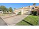 Single story home featuring a well-manicured lawn, mature trees, and a two-car garage at 250 W Juniper Ave # 22, Gilbert, AZ 85233