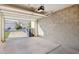 Garage with concrete flooring, block walls and automatic overhead door at 250 W Juniper Ave # 22, Gilbert, AZ 85233