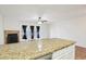 Bright kitchen boasts granite countertops, and open concept living area with fireplace and glass doors at 250 W Juniper Ave # 22, Gilbert, AZ 85233