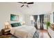 This bedroom has wood floors, large windows, and is virtually staged for your viewing at 250 W Juniper Ave # 22, Gilbert, AZ 85233