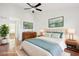 Bright main bedroom features a ceiling fan, wood floors, and stylish decor for a relaxing space at 250 W Juniper Ave # 22, Gilbert, AZ 85233