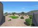 Low maintenance backyard design with decorative rock, lush bushes, and artificial turf at 30446 W Picadilly Rd, Buckeye, AZ 85396