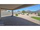 Backyard view with covered patio, decorative stone, and lush landscaping at 30446 W Picadilly Rd, Buckeye, AZ 85396