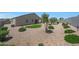 This home features a xeriscaped backyard with artificial turf, stone, and shrubbery at 30446 W Picadilly Rd, Buckeye, AZ 85396