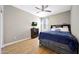 Bedroom featuring a bed, dresser, laminate floors, fan and neutral paint at 30446 W Picadilly Rd, Buckeye, AZ 85396
