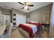 Bedroom with wood look flooring, neutral paint, fan and a large closet at 30446 W Picadilly Rd, Buckeye, AZ 85396