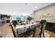 Open concept dining room featuring a large table and chairs, adjacent to the living room at 30446 W Picadilly Rd, Buckeye, AZ 85396