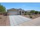 Charming single-story home showcasing a well-manicured lawn and a spacious two-car garage with a wide driveway at 30446 W Picadilly Rd, Buckeye, AZ 85396