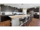 Bright kitchen with a granite island and bar stool seating, complemented by stainless steel appliances at 30446 W Picadilly Rd, Buckeye, AZ 85396