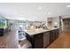 An open kitchen with stainless steel appliances and a large island flows into the living area at 30446 W Picadilly Rd, Buckeye, AZ 85396