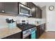 Modern kitchen features stainless steel appliances, granite countertops, and dark wood cabinets at 30446 W Picadilly Rd, Buckeye, AZ 85396