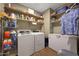 Laundry room featuring a washer, dryer, freezer, shelving, and wood-look flooring at 30446 W Picadilly Rd, Buckeye, AZ 85396