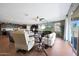 Spacious living room featuring hardwood floors, sofas, a ceiling fan and sliding glass doors at 30446 W Picadilly Rd, Buckeye, AZ 85396