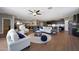 Bright open concept living room with hardwood floors, comfortable seating and decor at 30446 W Picadilly Rd, Buckeye, AZ 85396