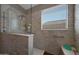 Glass enclosed shower with marble-look surround, a built in bench and safety bars at 30446 W Picadilly Rd, Buckeye, AZ 85396