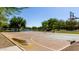 Outdoor basketball court with a serene backdrop of trees and a pond at 3578 E Walnut Rd, Gilbert, AZ 85298