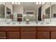 Bathroom featuring dual sinks, wood cabinets, and a glass-enclosed shower at 3578 E Walnut Rd, Gilbert, AZ 85298