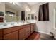 Bathroom featuring dual sinks, wood cabinets, and large mirrors with recessed lighting at 3578 E Walnut Rd, Gilbert, AZ 85298