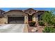 Beautiful single-story home with a two-car garage, desert landscaping, and a charming entryway at 3578 E Walnut Rd, Gilbert, AZ 85298