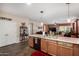 Open kitchen with stainless steel sink, wood cabinets and view into the Gathering room at 3578 E Walnut Rd, Gilbert, AZ 85298